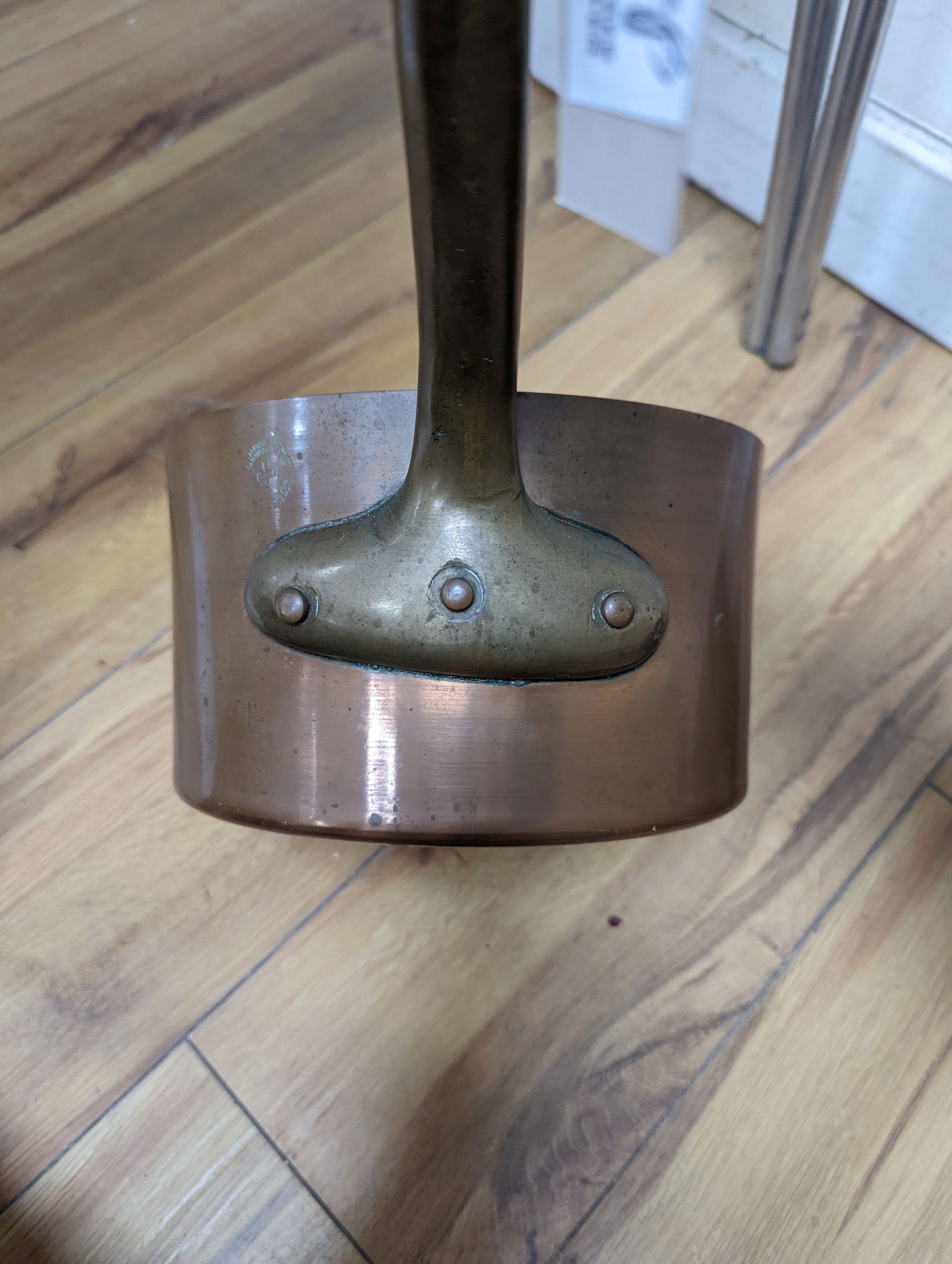 A group of three Jaeggi & Sons copper saucepans